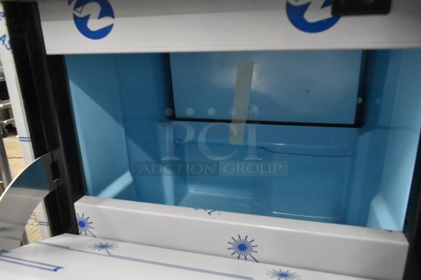Brand new Avantco 194EUCH130A undercounter ice machine. Interior view showing clean, blue compartment. 115 Volts, 1 Phase.