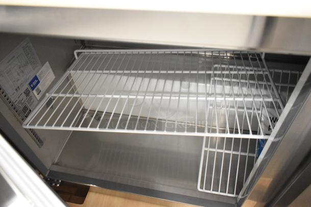 Brand new Avantco 178APT60HC commercial prep table, scratch and dent, 115V, 1 phase, interior view with shelves.