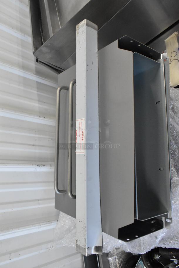 Avantco 177FF50L deep fryer wall bracket, gray metal, labeled "FRAGILE," part of a commercial propane fryer set.