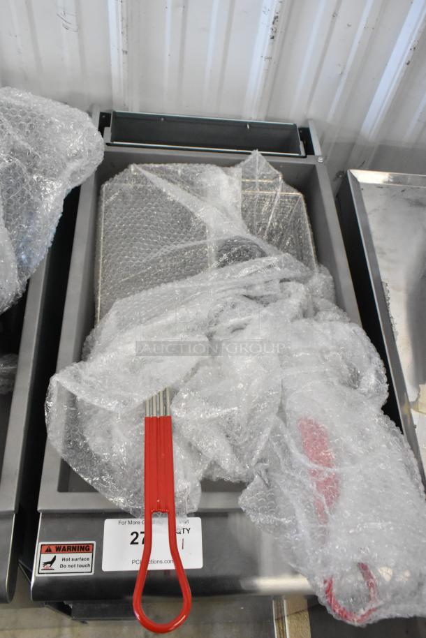Brand new Avantco 177FF50L propane fryer, 120,000 BTU, with 2 metal baskets. Wrapped in bubble wrap, red handle visible.