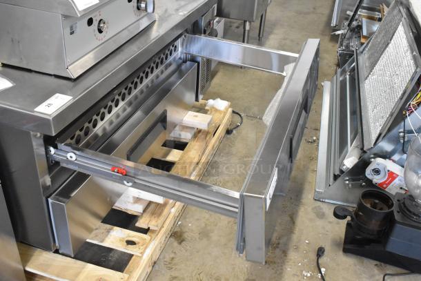 Brand new Avantco 178CBE52HC commercial 2-drawer chef base, 115 volts, on casters; minor scratches and dents visible.