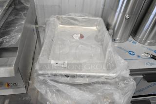 3 new Vollrath aluminum sheet pans, model 9001, in plastic wrap. Slight scratch and dent. Auction lot tag visible.