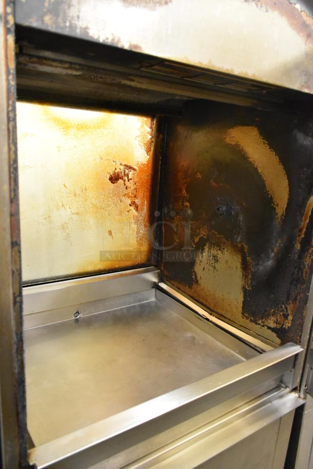 Fri-jado TDR7-P commercial rotisserie oven interior with visible wear, stainless steel surfaces, 208V, 3 phase, on casters.