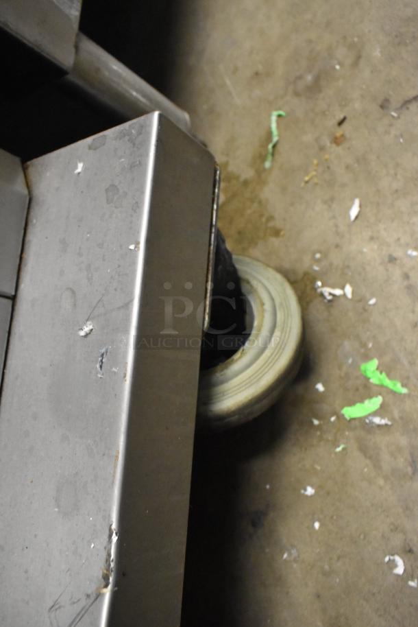 Fri-jado TDR7-P commercial rotisserie oven caster and stainless steel side, showing some wear. Electric, 208V, 3-Phase.