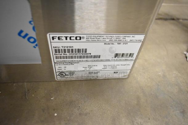 2023 Fetco TBS-2121 Iced Tea Machine tag showing model, SKU T212101, serial number, 120V, 1 phase. Brand new with scratch and dent.