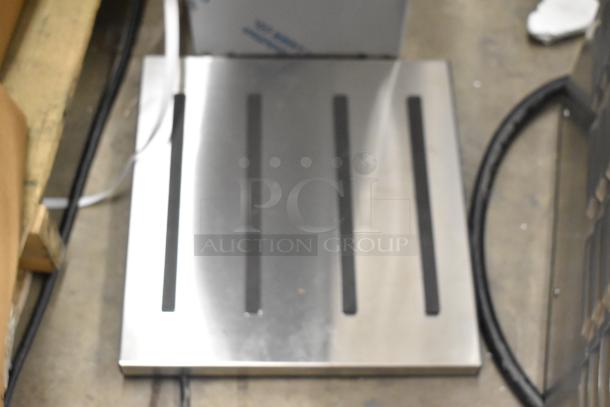 Brand new 2023 Fetco TBS-2121 iced tea machine with scratch and dent, 120 volts, 1-phase, stainless steel panel shown.