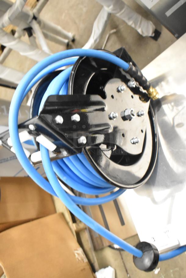 Brand new Regency hose on reel, blue hose, metal frame, minor scratches, ideal for industrial use.