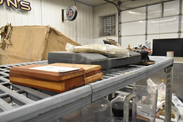 Assorted items including sharpening stones, probe kit, and Well 8200N soldering gun on a metal shelf. Conditions vary.