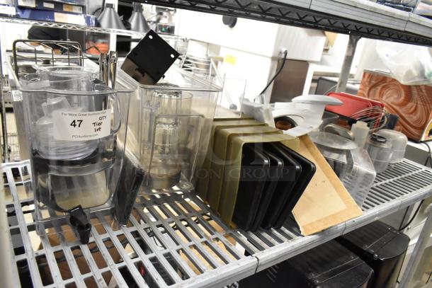 Lot of clear poly bins and lids with metal shelving. Includes various kitchen items. Condition appears used. Auction tag visible.