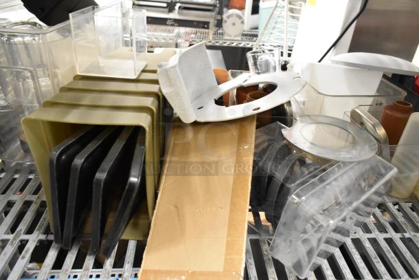 Lot of clear poly bins and lids, assorted sizes. Includes metal frame and cardboard sheet. Mixed condition, ideal for storage.