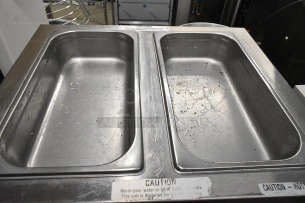 Duke CSW-2-T-AM countertop 2 well food warmer, 120 volts, used condition with visible wear and residue in wells. Caution labels present.