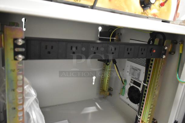 BlackShields DC0300 white metal technology cabinet with air conditioning, interior view showing power outlets and cooling fan.