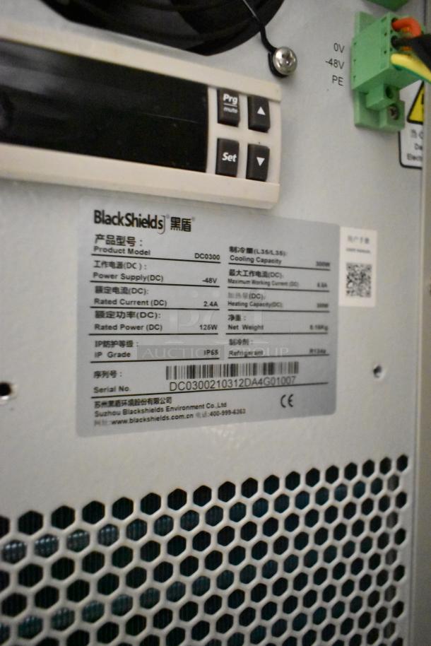 BlackShields DC0300 white metal air-conditioned technology cabinet, model details and control panel visible, IP55 rated.