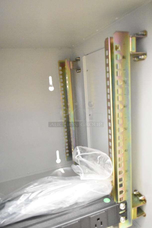 BlackShields DC0300 air conditioned cabinet, white metal, new; interior view showing mounting rails and packaged accessories.