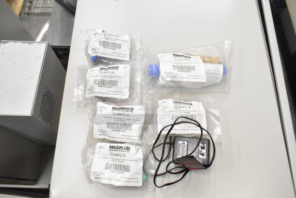 Lot of various items including Marinco CLS40FB-D pin connector, CL40FC-A/B/C/E protective caps, each in packaging.