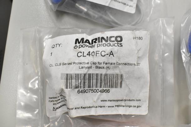 Lot of Marineco products including CLS40FB-D pin connector, multiple CL40FC series protective caps, in original packaging.