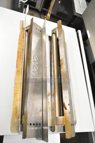 Nine metal components for Turbochef rapid cook conveyor ovens, showing visible rust and wear, embossed with "2020".