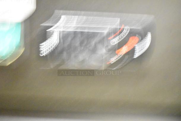 Blurry image, unclear details of the Coldline D12-B commercial reach-in freezer merchandiser.