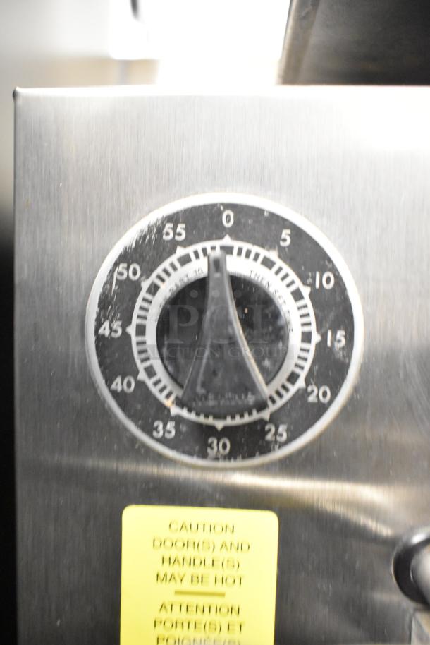 Cleveland PGM3002 commercial propane steamer control panel, timer dial, and caution label visible.