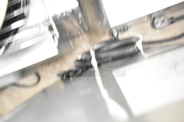 Blurry image showing parts of the Manitowoc UDP0065A-161 ice machine; details not clear.
