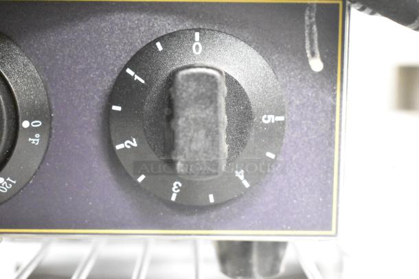 Carnival King 382BWM30 waffle maker timer dial, showing numbering and settings on black background.