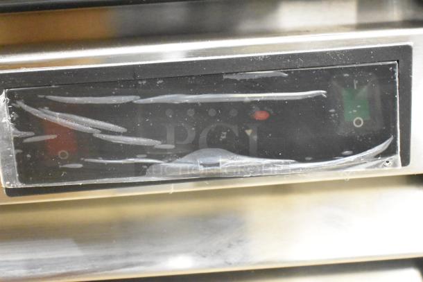 Control panel of Atosa MCF8703ES commercial freezer, featuring labeled switches, protective film, and visible wear.