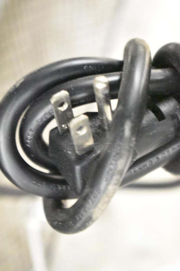 Close-up of a power plug and cord for the 2021 Atosa MCF8703ES commercial freezer.