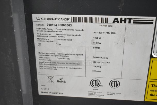 AHT AC-XLS US metal commercial open merchandiser label, 115V, 1 Phase, specs visible, RoHS compliant, made in Austria.