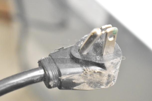 Close-up of a worn electrical plug from the PHCBI SF-L6111W Undercounter Cooler, 120 Volts, single phase.