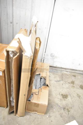 Four boxed items, including Bon Chef 52109 EX Fit Tile Pattern Tabletop, metal oven racks, and legs, visible damage on boxes.