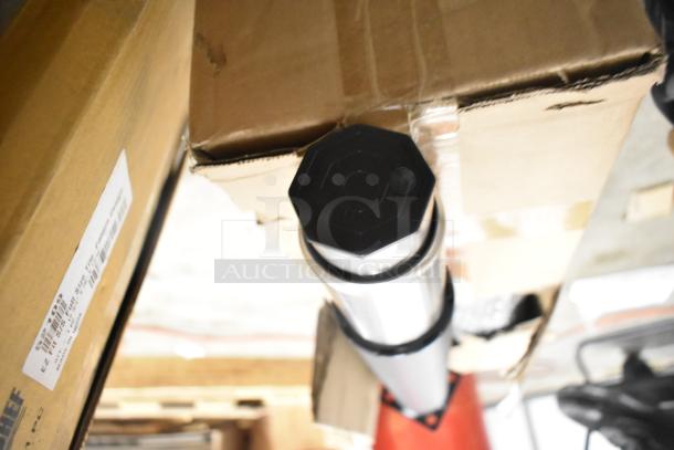 Boxes containing new scratch and dent Bon Chef 52109 EX Fit Tile tabletop, legs, and metal oven racks.