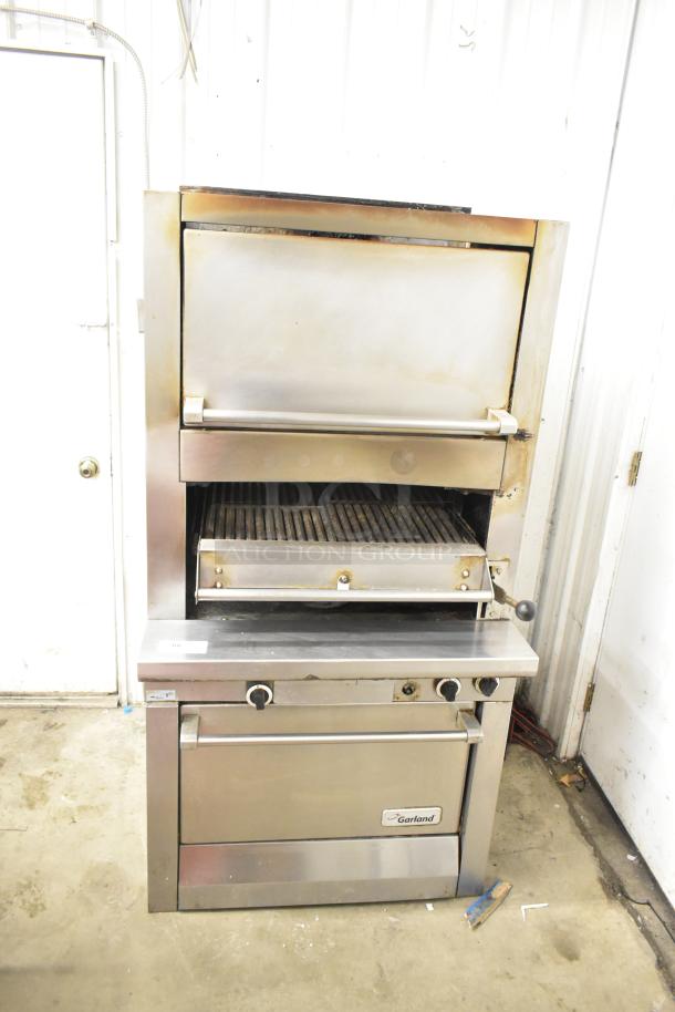 Garland stainless steel commercial gas upright broiler, used condition, featuring adjust knobs and branded label. Ideal for restaurants.
