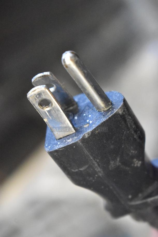 Close-up of a power plug for the 2016 Bunn LCA-1 coffee dispenser, 120 volts, showing a three-prong connection.