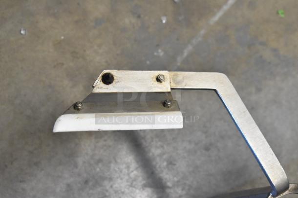 Metal auger with sturdy blade and handle, showing signs of wear. Bolted connections visible on both parts.