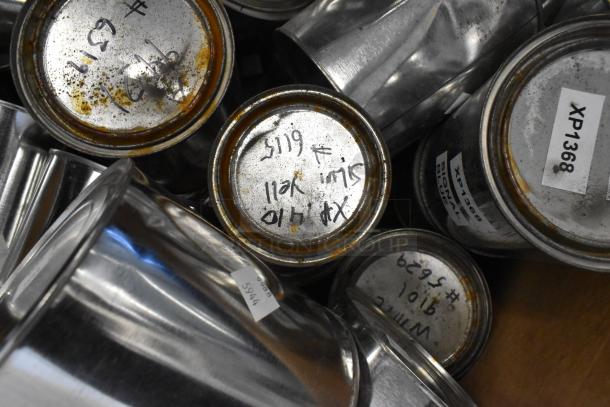 Assorted cans of Pro Guard Chemicals, including ProFlex 1501 Part A and B, with visible labels and markings indicating contents.