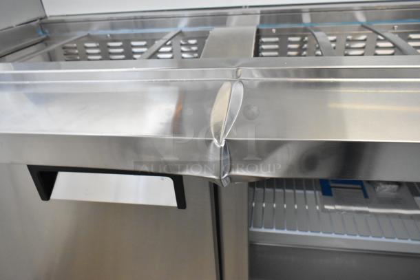 Brand new Avantco 178APT60MHC 60" 2-door refrigerated prep table showing minor dent on the stainless steel surface.