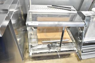 ServIt 423HDM26SA heated display case with sliding doors. Features glass damage. Measures 26 inches, 120V, 1 phase.