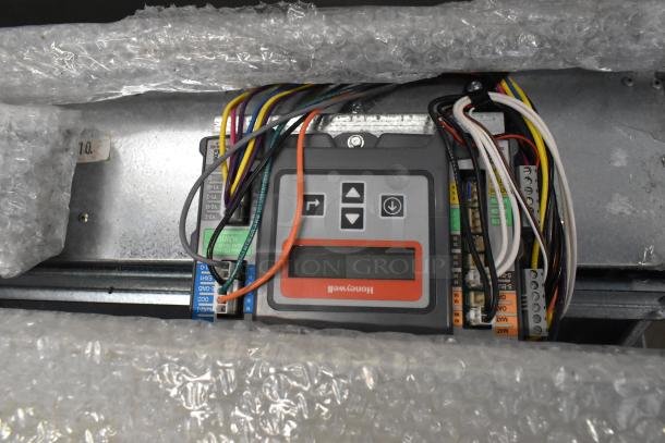 Brand new Daikin Hood with McDaniels Metal 122-DK-090, featuring a vertical/downflow low leak Jade Economizer, wrapped in bubble wrap.