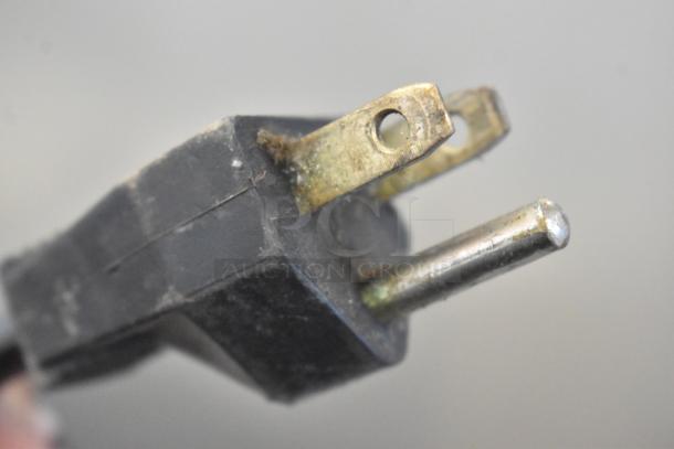 Three-prong power plug of the Bunn ES-1G espresso grinder, showing slight wear, compatible with 120 Volts and 1 Phase.