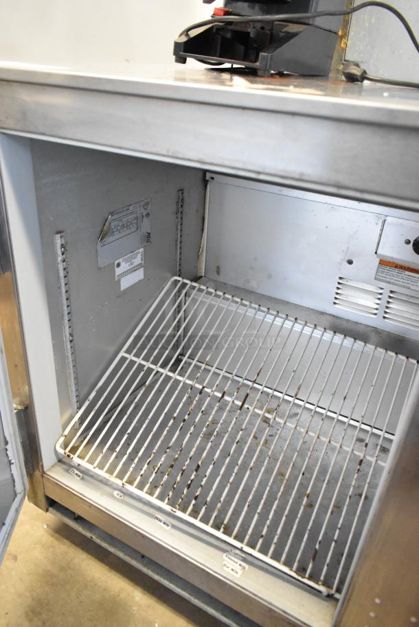 Beverage Air UCR48A undercounter cooler, 2 doors, on casters, visible shelving, 115 volts, 1 phase, commercial use, fair condition.