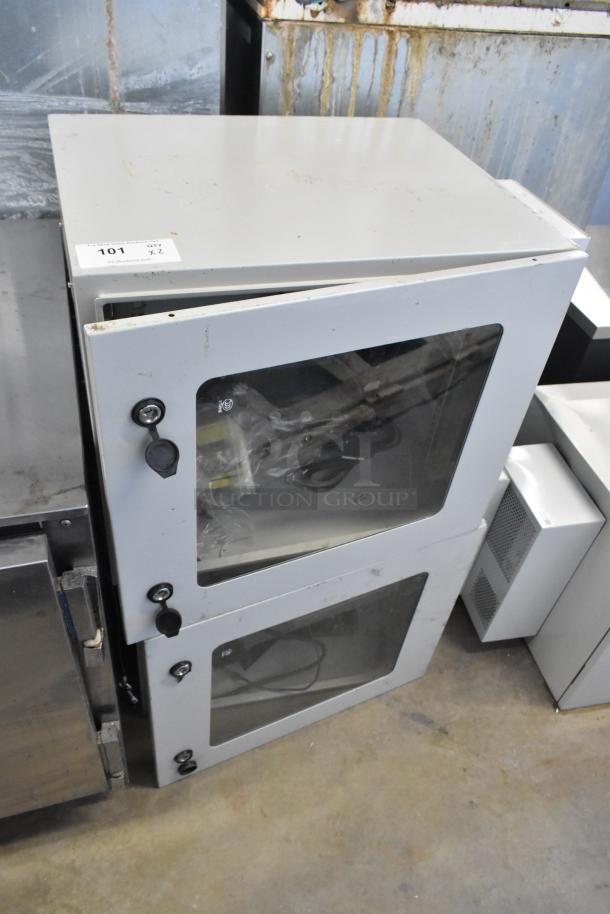 2 BlackShields DC0300 white metal air-conditioned cabinets with dual locking doors, used condition, visible lot label "101."