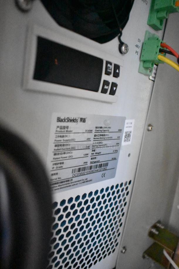 BlackShields DC0300 white metal air-conditioned technology cabinet with control panel and ID label detailing model and specs.