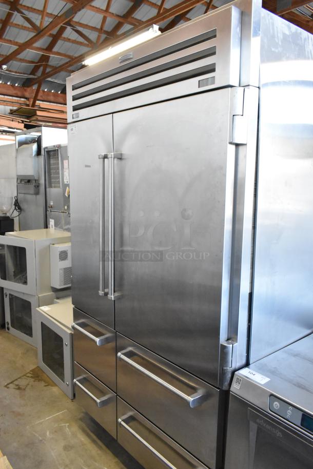 Sub-Zero reach-in cooler with freezer, stainless steel, dual handles, excellent condition, branded label above doors.