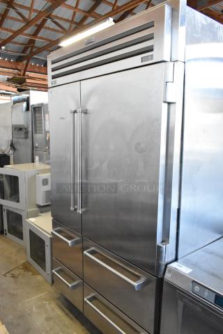 Sub-Zero reach-in cooler with freezer, stainless steel, dual handles, excellent condition, branded label above doors.