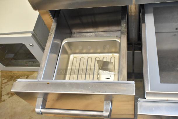 Sub-Zero reach-in cooler with freezer, stainless steel, clean interior with a removable pan, sturdy handle, excellent condition.