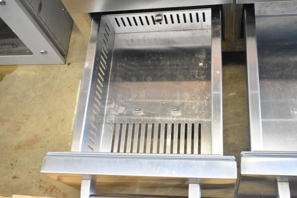 Sub-Zero reach-in cooler drawer with visible stainless steel interior and venting, indicating cooling functionality. Clean condition.