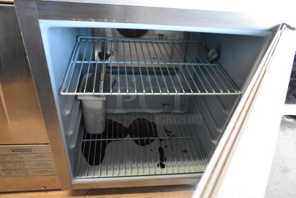 Delfield 406CA-DD1 commercial undercounter cooler, single door, 115 volts, on casters, interior shelves visible.