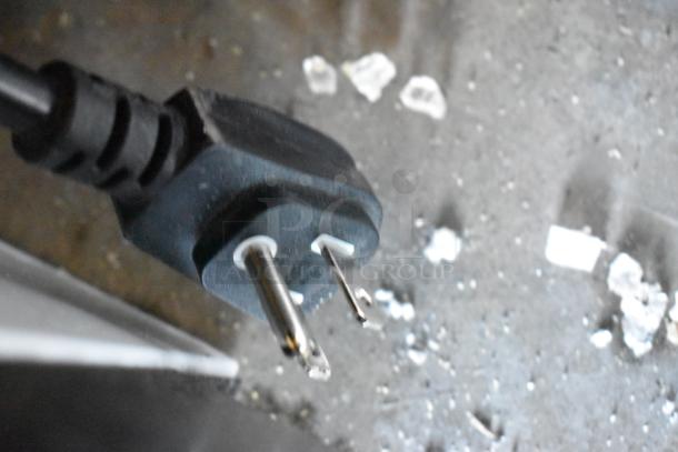 A close-up of a power plug connector for the 2019 Habco SE18HC cooler, shows prongs and black casing.