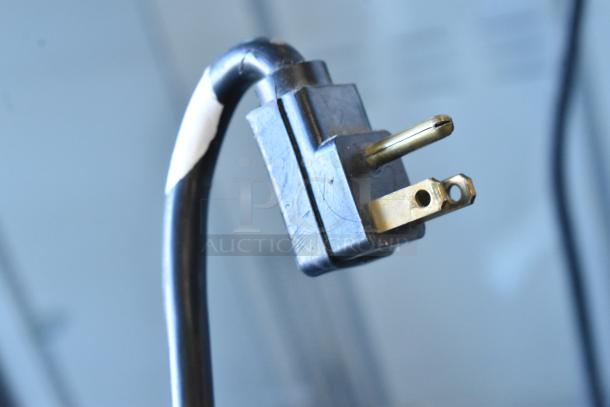 Close-up of a power plug for the Traulsen RHT232WUT-HHS Reach In Cooler, showing a standard 115V, 1-phase US plug.