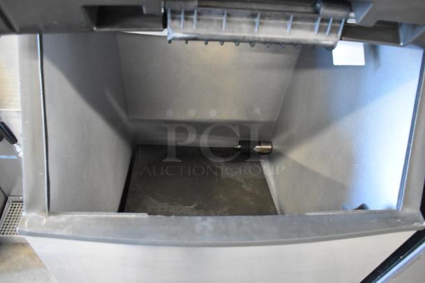 Manitowoc SD0602A commercial ice head on ice bin, 208-230V, 1 phase, viewed from above, clean interior, robust condition.